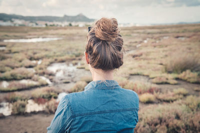 Rear view of woman standing on land