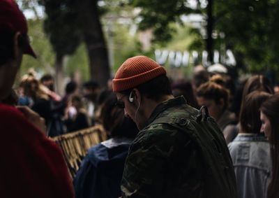 Group of people standing against trees at park