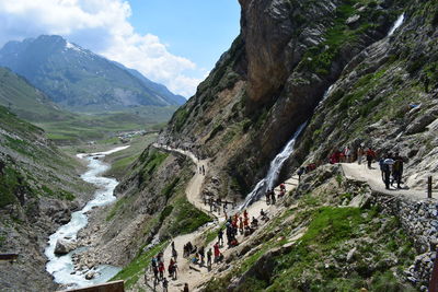 High angle view of people by mountains against sky