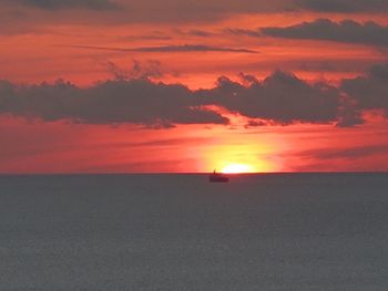 Scenic view of sea against romantic sky at sunset