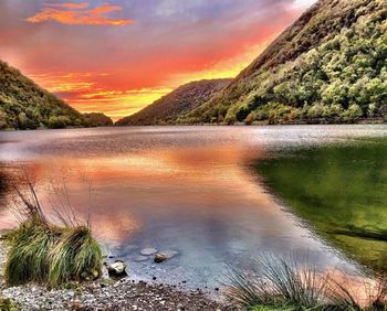 Scenic view of lake against sky during sunset
