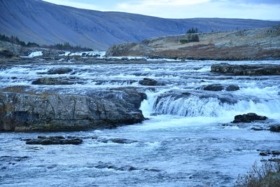 Scenic view of river against sky during winter