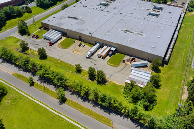 High angle view of road amidst trees and buildings