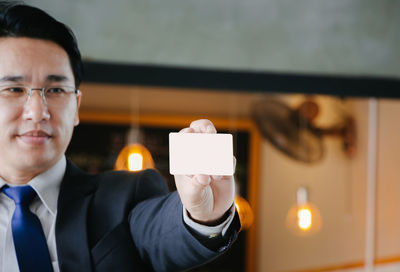 Portrait of man holding lit candle