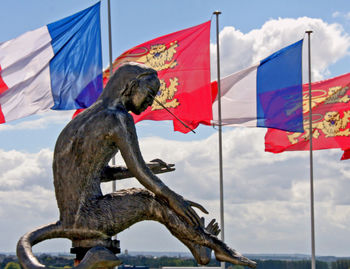 Low angle view of statue against flags