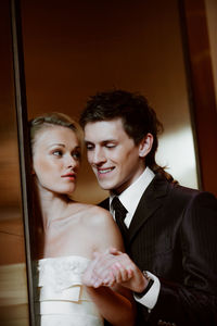 Couple standing by door at home