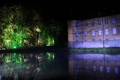 Reflection of trees in water at night