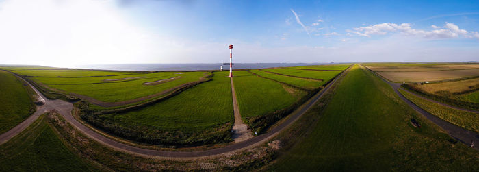 Panoramic shot of road amidst land against sky