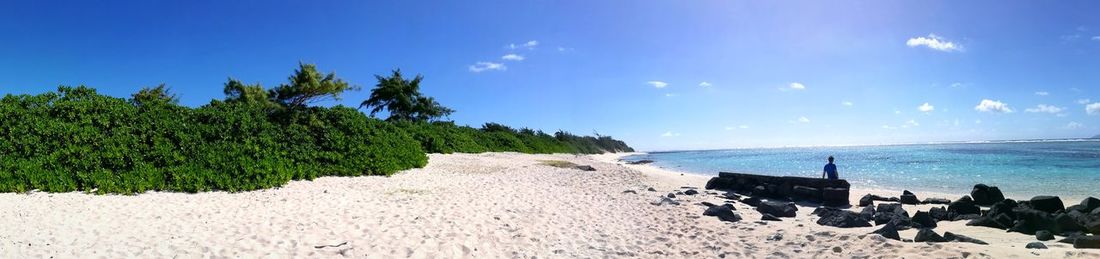 Panoramic view of beach against clear blue sky