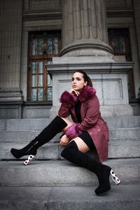 Full length of woman sitting on steps