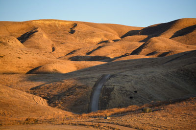 Scenic view of rolling hills against sky