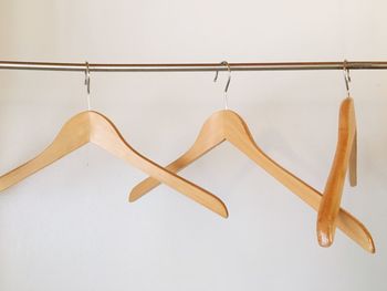 Coathangers hanging against white background