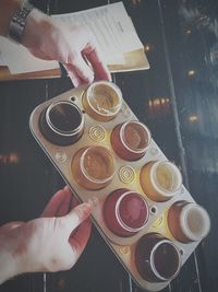 High angle view of hand holding coffee cup on table