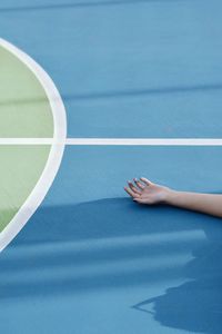 Cropped hand of woman on court