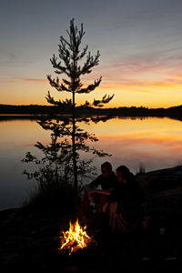 Scenic view of lake against romantic sky at sunset