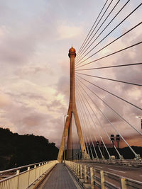 View of suspension bridge against cloudy sky