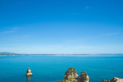 Scenic view of sea against blue sky