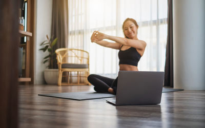 Young woman exercising in gym