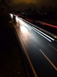 Light trails on road in city at night