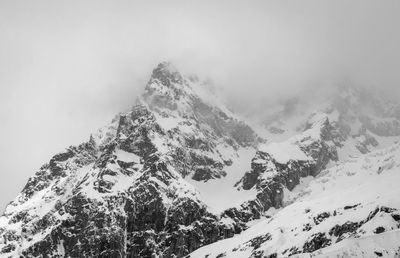 Scenic view of snow covered mountains against sky