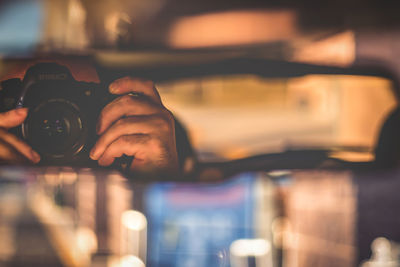 Close-up of hand holding camera