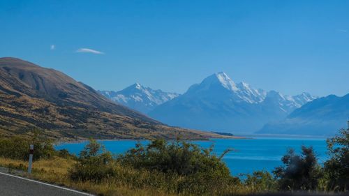 Scenic view of mountains against blue sky