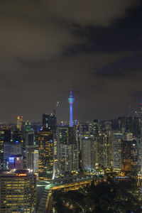 Illuminated cityscape against sky at night