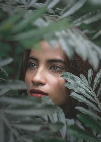 Portrait of young woman with leaves