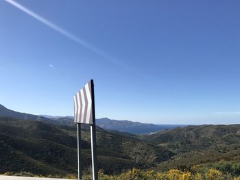 Scenic view of mountains against blue sky