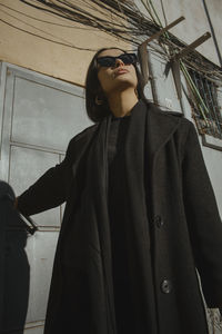 Low angle view of young woman looking at camera