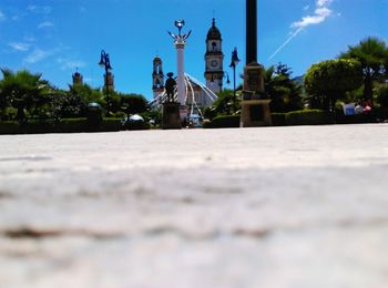 Surface level view of street amidst buildings against sky