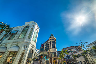 Low angle view of buildings against blue sky