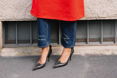 Low section of woman walking on street