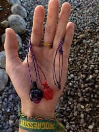 Close-up of woman hand on rock