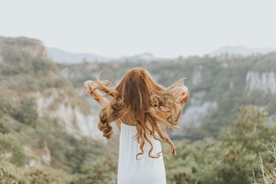 Midsection of woman standing on mountain