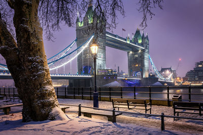 Illuminated suspension bridge in city at night