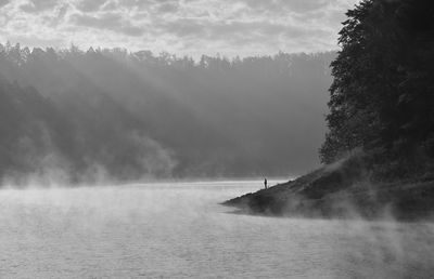 Scenic view of river during foggy weather