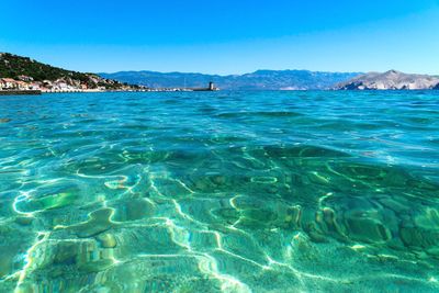 Scenic view of sea against clear blue sky