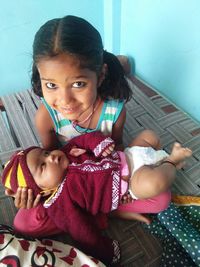 Portrait of smiling girl sitting at home