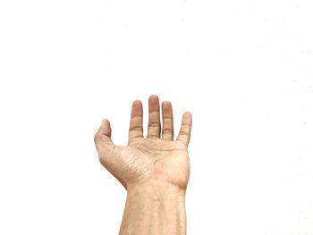 Close-up of hand against white background