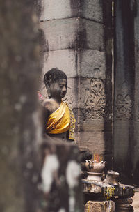 Statue of buddha against building