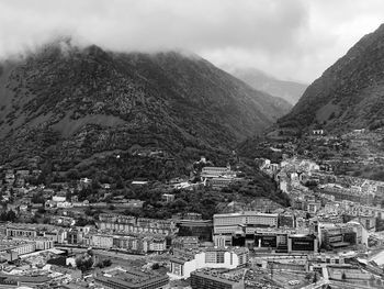 High angle view of townscape and mountains against sky