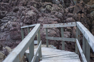 High angle view of footbridge over rocks