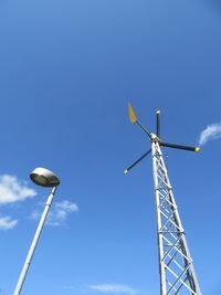 Low angle view of windmill against clear blue sky