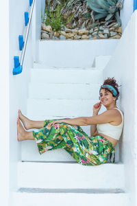 Woman laughing on tropical holidays in stairs. woman on the beach on spanish travel destination.