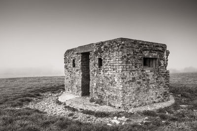 Old ruin building on field against clear sky