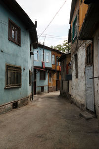 Empty alley amidst buildings in city