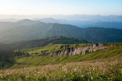 Scenic view of landscape and mountains against sky