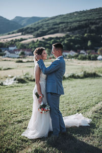 Rear view of couple holding hands