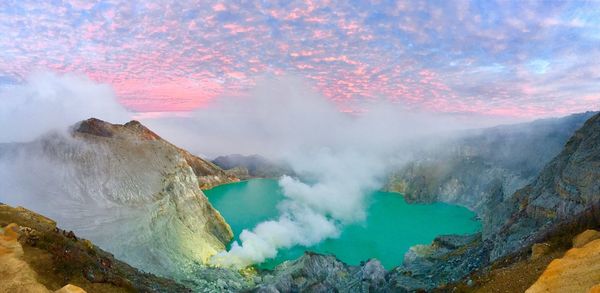 Smoke emitting from volcanic mountain against sky